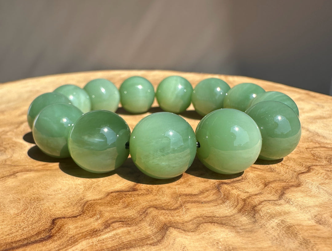 green jade beads on base