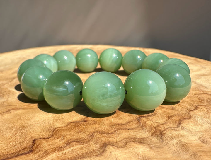 green jade beads on base