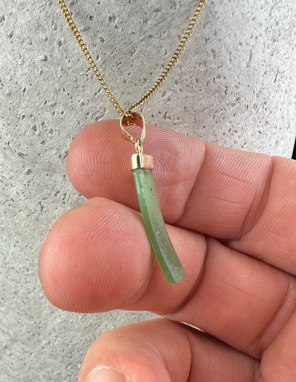 Close up of Vintage Rectangle Drop Pendant showing green rectangular stone with gold cap and bail on a gold chain