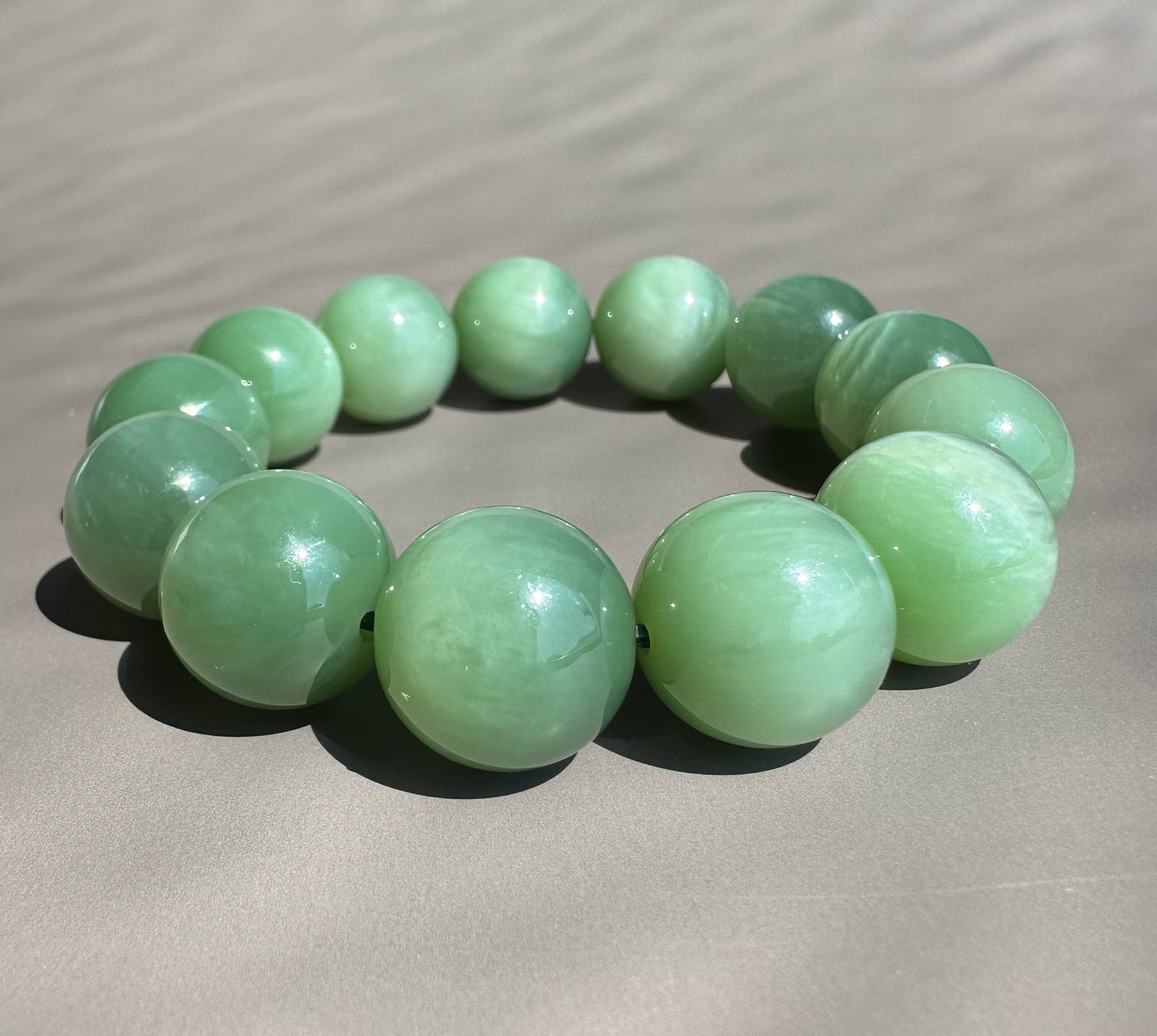 16mm green jade beads on grey base
