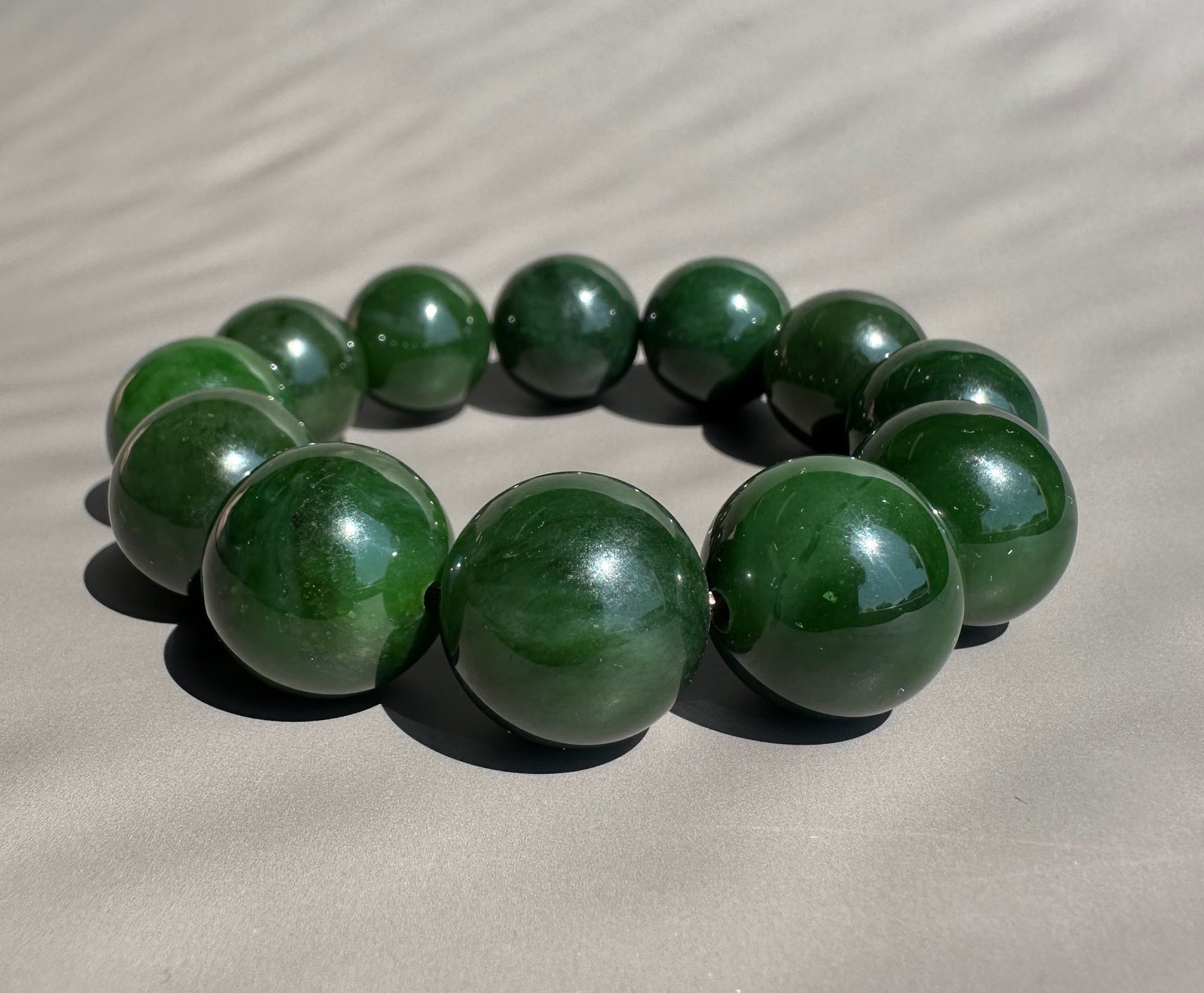 jade beads on grey background