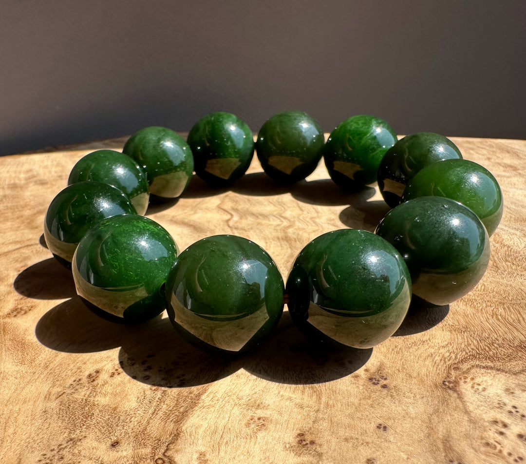 dark green jade on wooden base