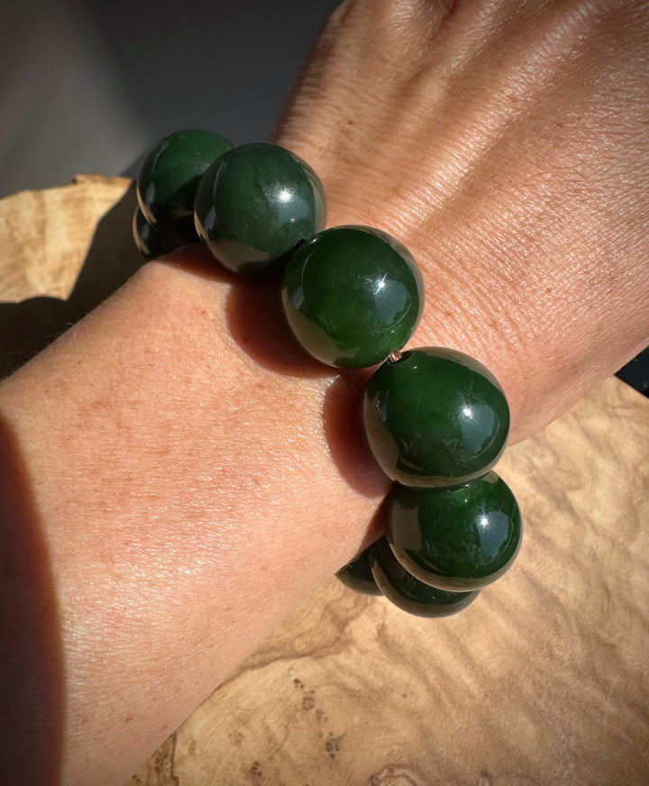 geen jade beads on a wrist