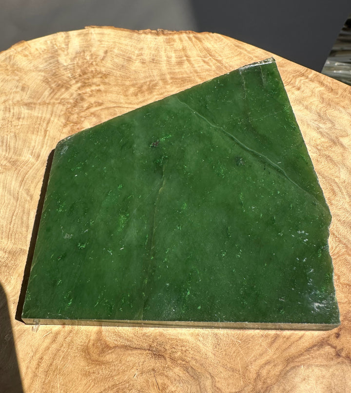 green jade slab on wooden base