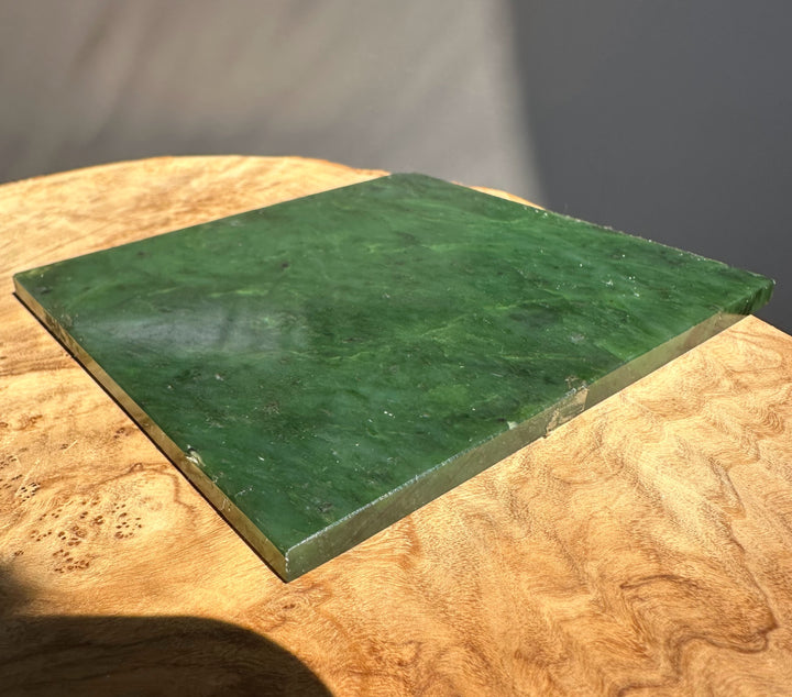 green jade slab on wooden base