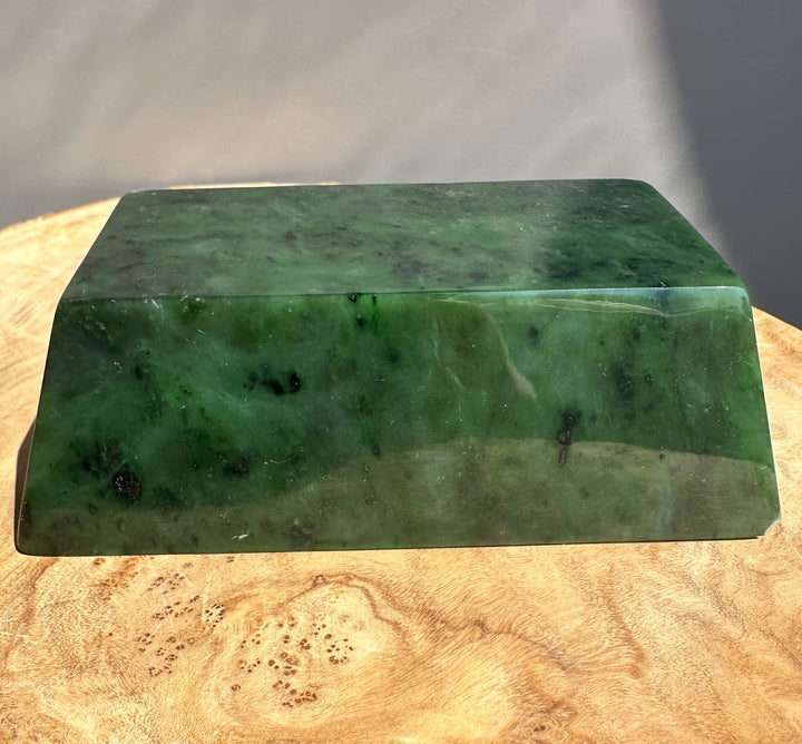 green jade ingot on wooden base