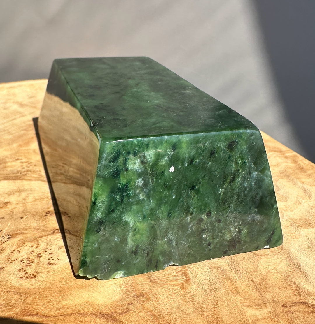 Green jade ingot on wooden base
