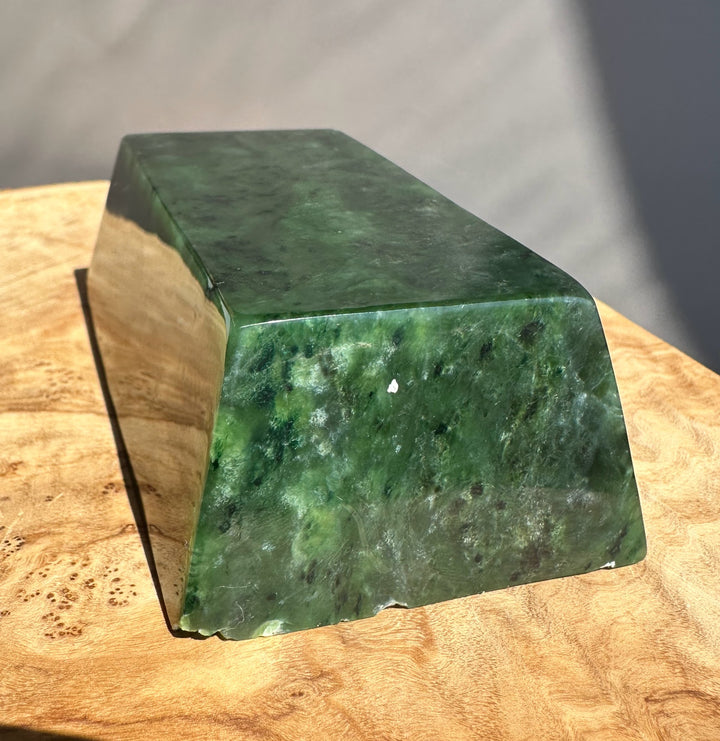 Green jade ingot on wooden base