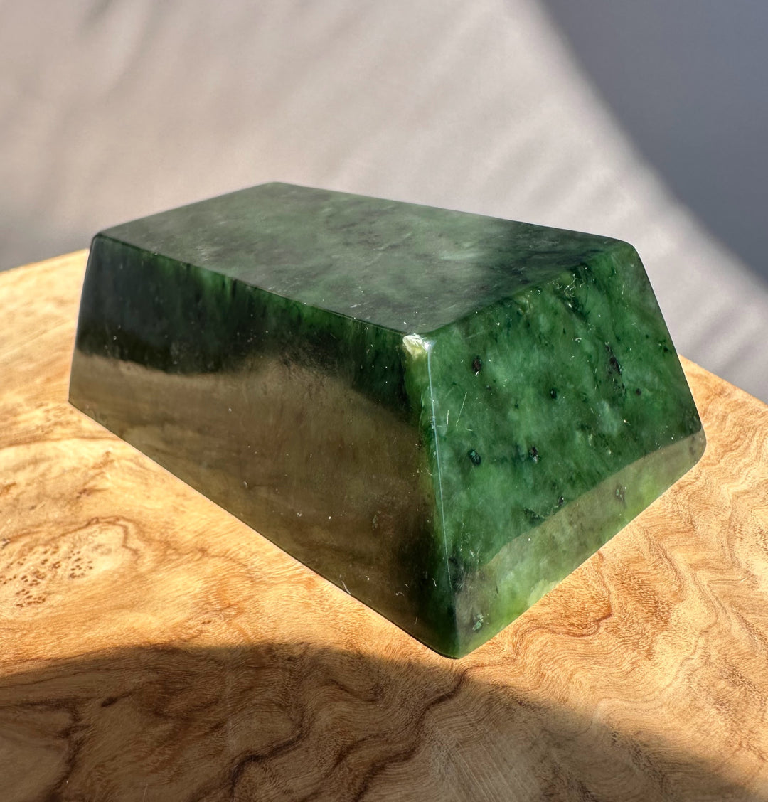 Green jade ingot on wooden base