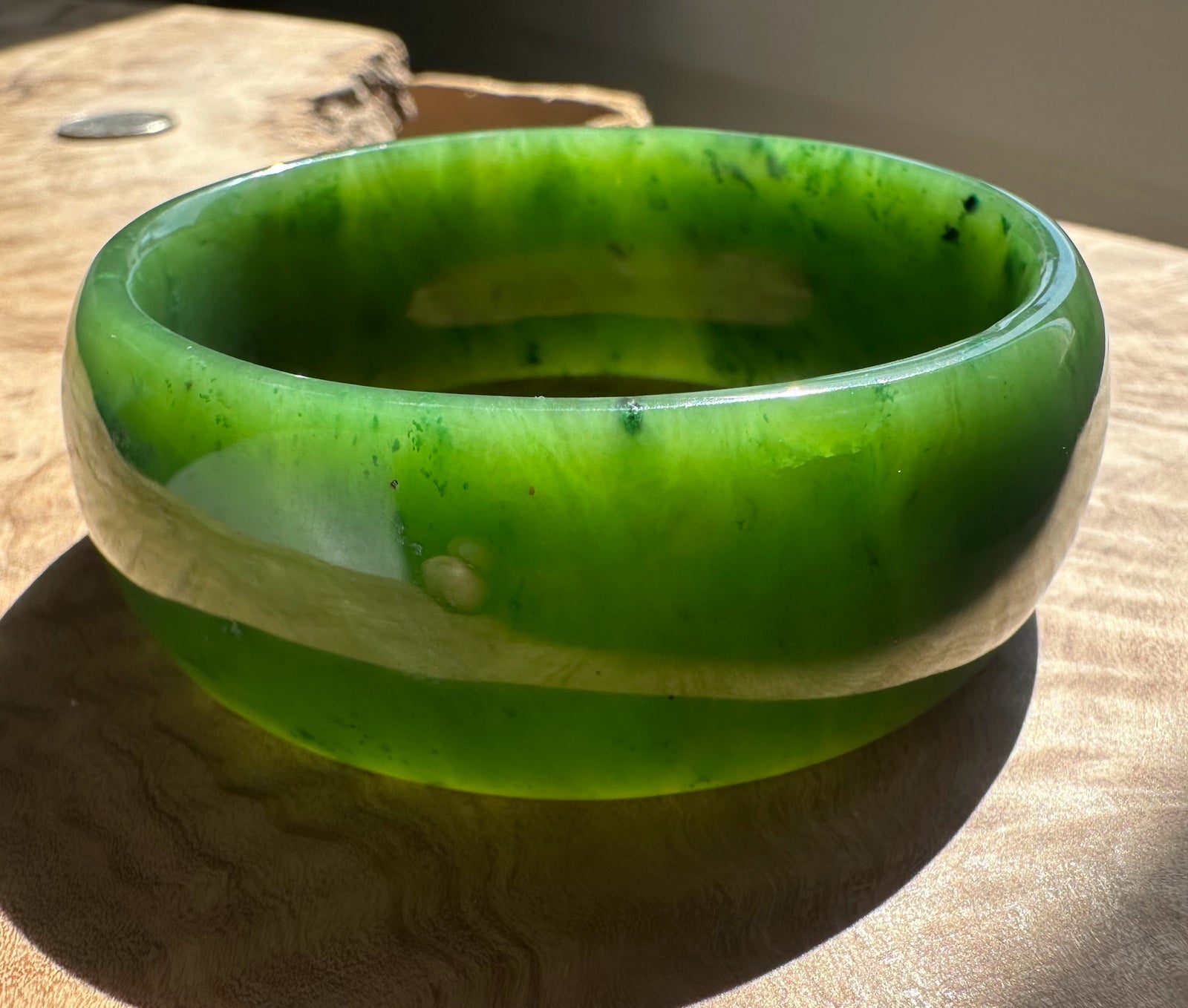 Green jade bangle worn on the wrist
