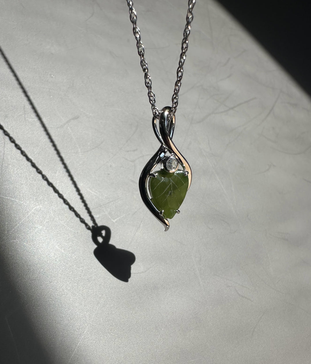 Close-up of the chain and bail for the jade leaf infinity pendant.