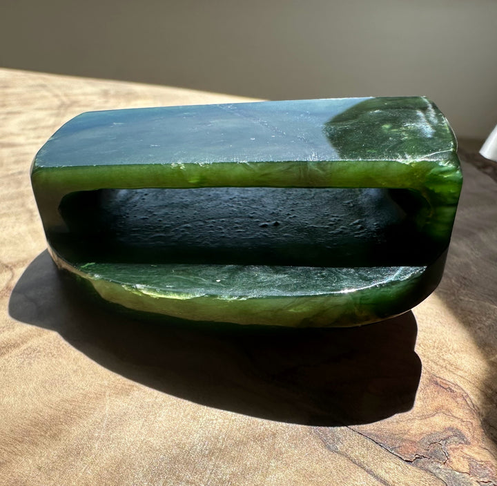 Polished jade belt buckle 49mm wide in deep green with a rounded edge