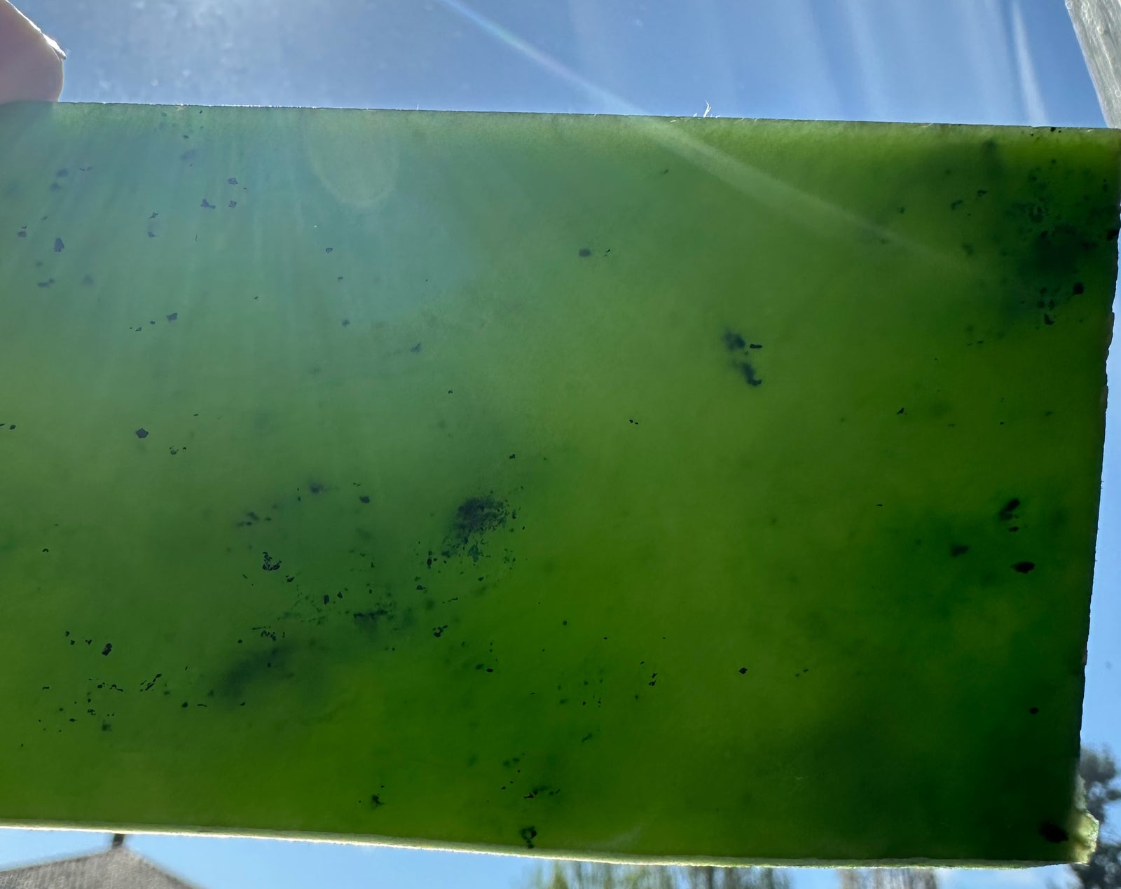 green jade being held up to the sun