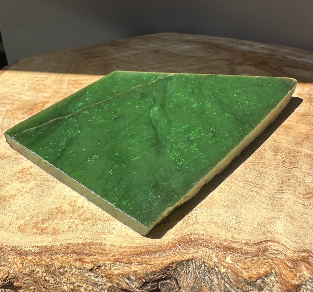 A Grade Canadian Jade slab weighing 195 grams placed on a wooden surface