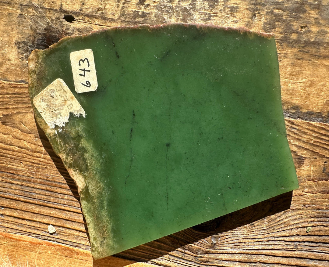 Wyoming Apple 85g green mineral slab with sticker labels on a wooden surface