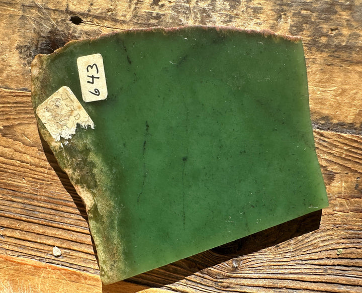 Wyoming Apple 85g green mineral slab with sticker labels on a wooden surface