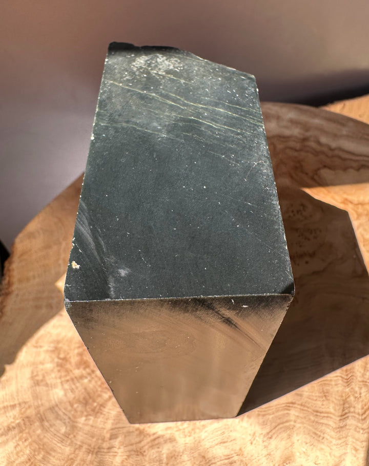 Wyoming slate block weighing 2lbs 9oz with a rough layered top on a wooden surface