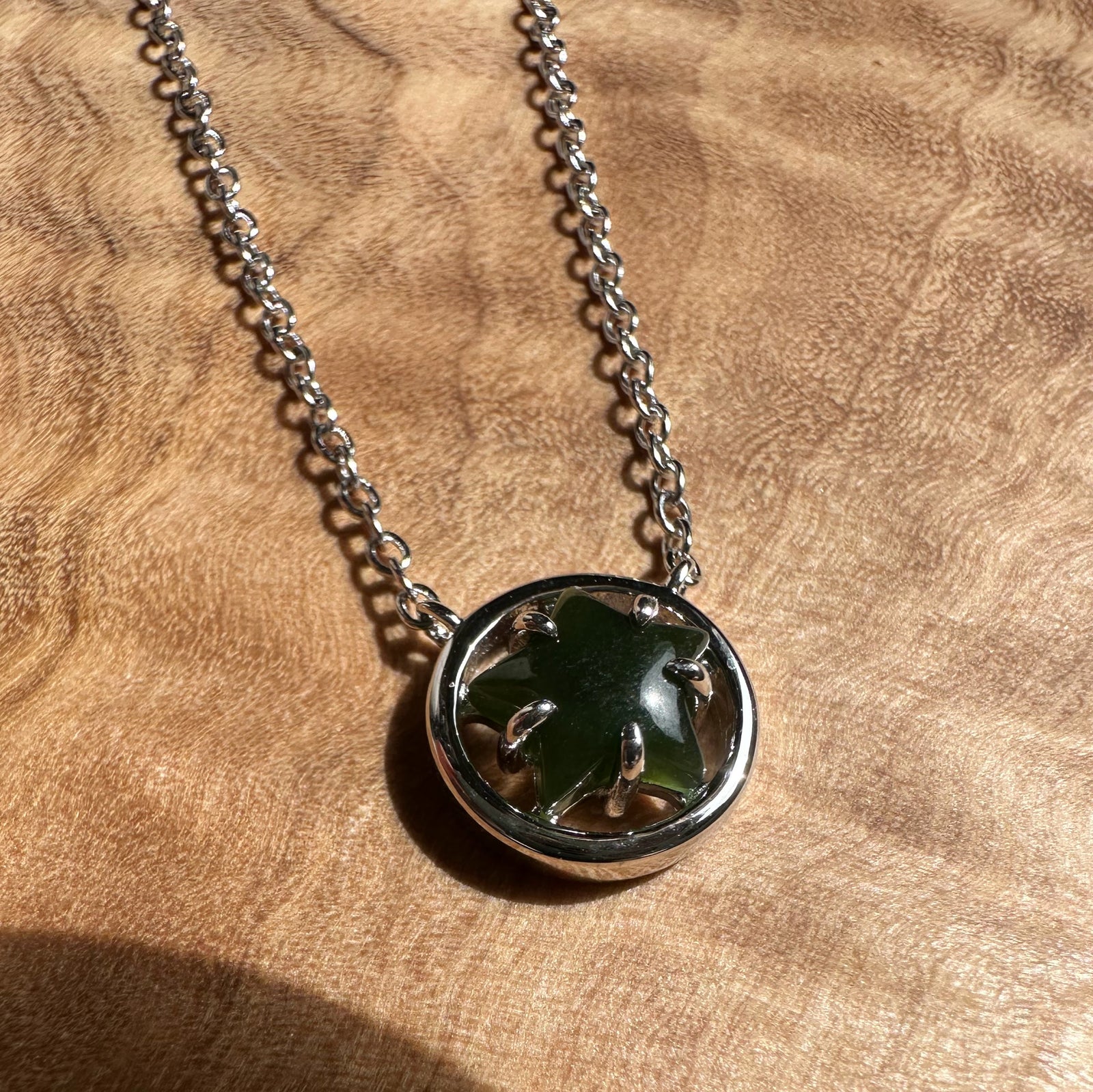 Canadian jade star pendant in a silver circular bezel on a chain