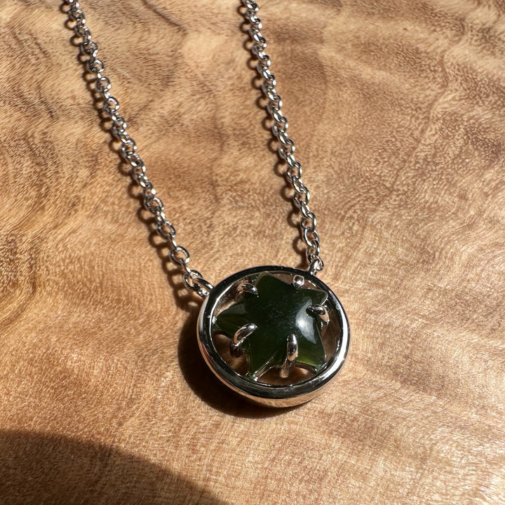 Canadian jade star pendant in a silver circular bezel on a chain