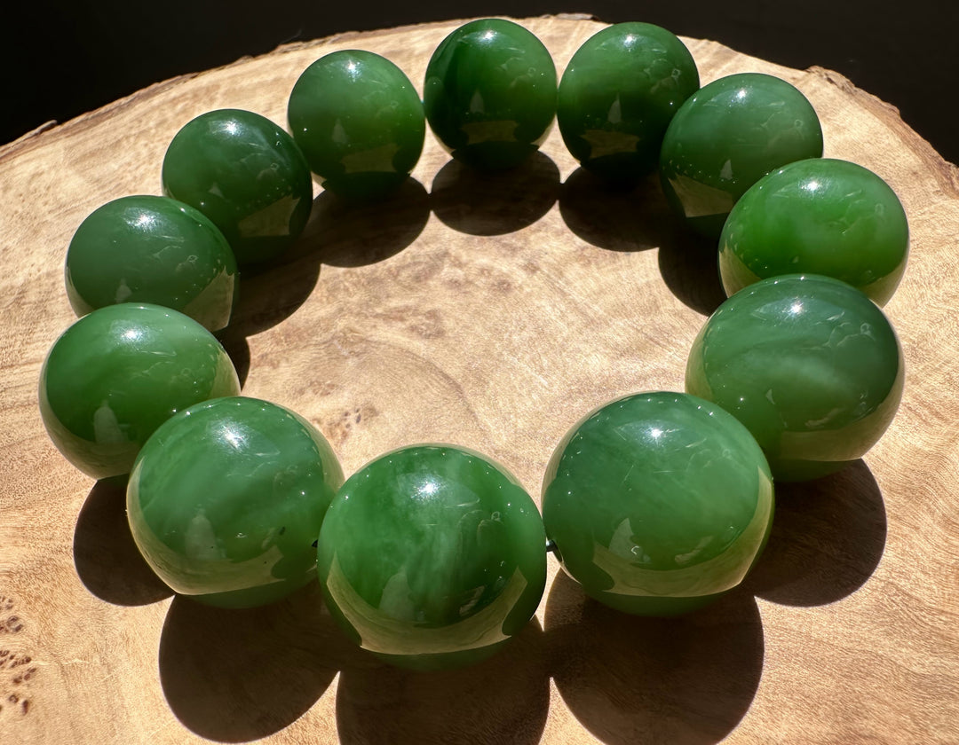 Top view of a circular 18mm AA Siberian Bead Bracelet laid on a wooden surface