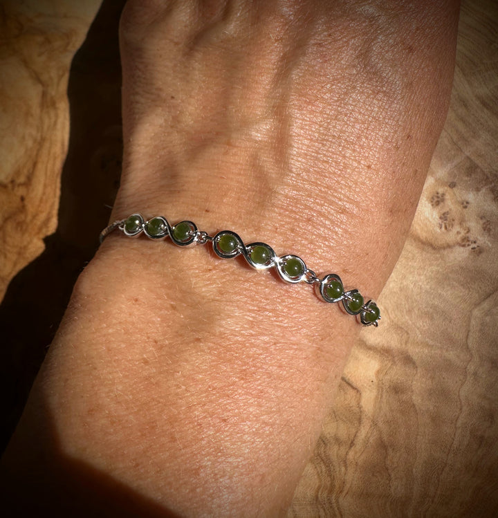 Wrist shot of sterling silver bracelet with round Canadian jade beads