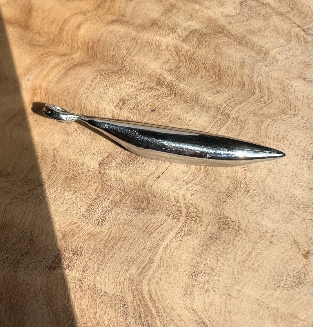 Jade Peapod Pendant in stainless steel a slender pod shaped pendant with a pointed tip