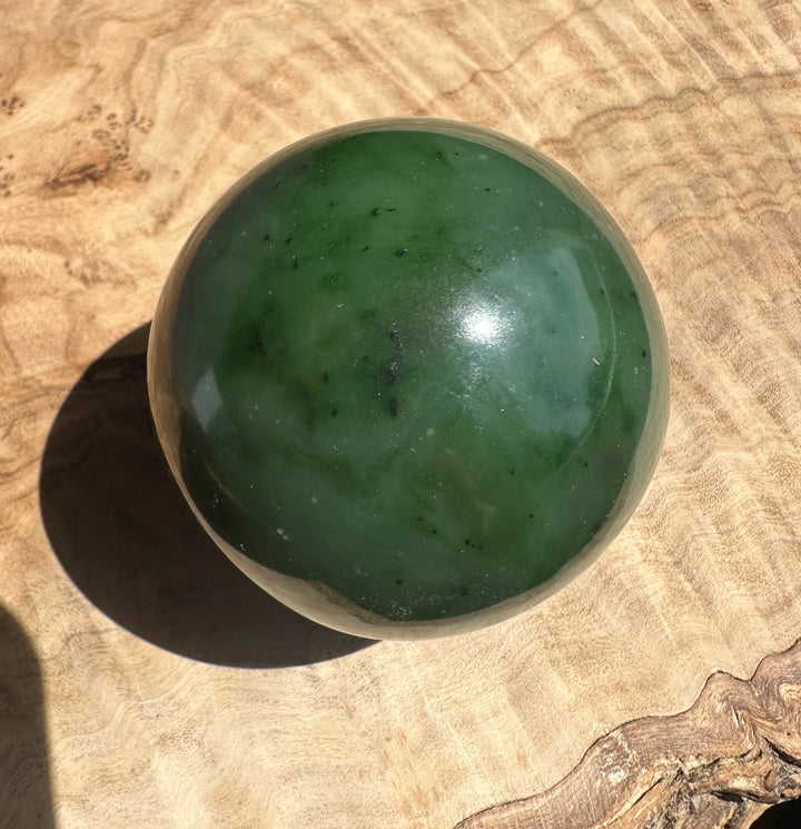 Green jade on a textured beige surface