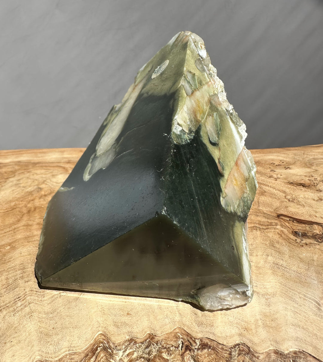 jade on a wooden surface with a dark background