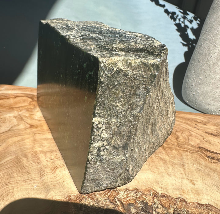 Cassiar Jade rough block with a flat polished face on one side and rugged natural edges.