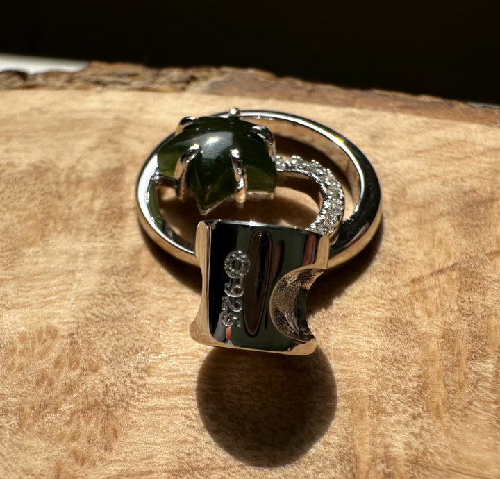 Canadian Jade and Silver Star and Moon Pendant showing green jade center within a circular silver frame and diamond accents