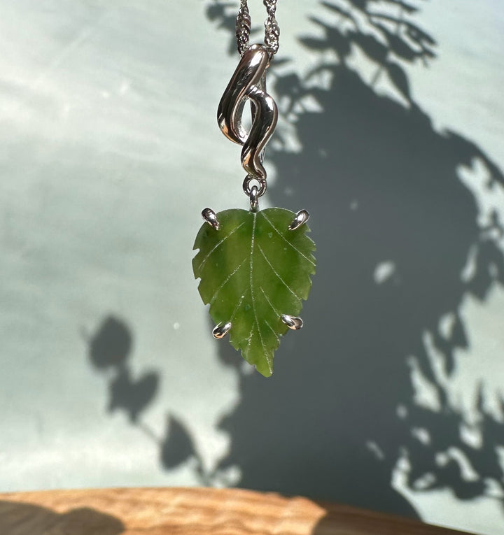 Silver leaf pendant on a chain with a decorative bail