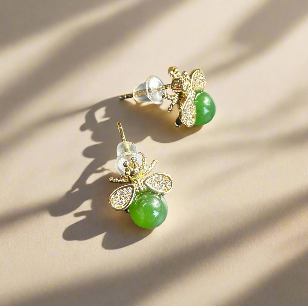 Gold bee earrings with a green jade body and diamond-studded wings