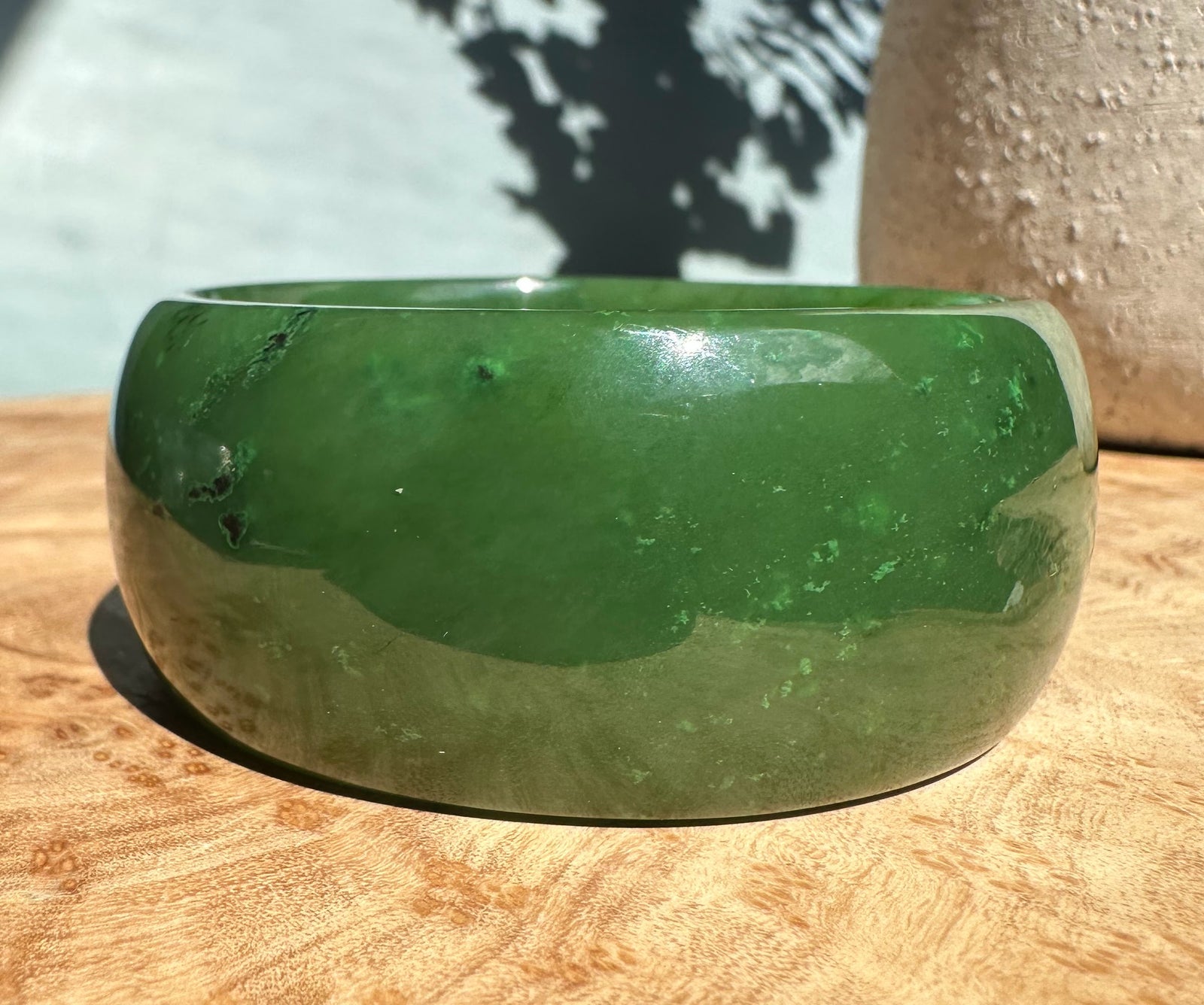 Wide Cassiar Jade Bangle with a thick green jade slab and a smooth silver rim