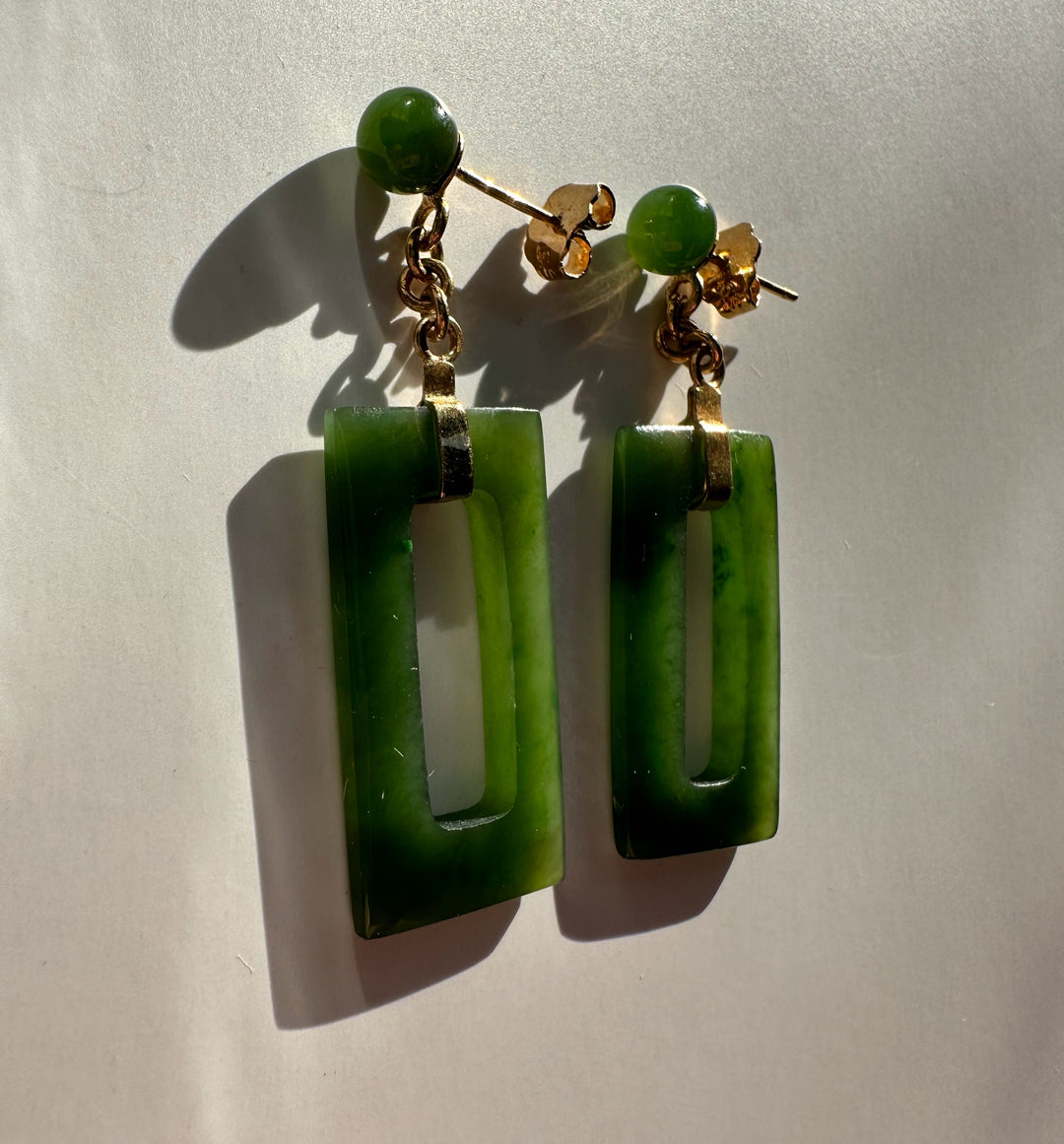 Vintage jade rectangle drop earrings with gold chain and round green studs.