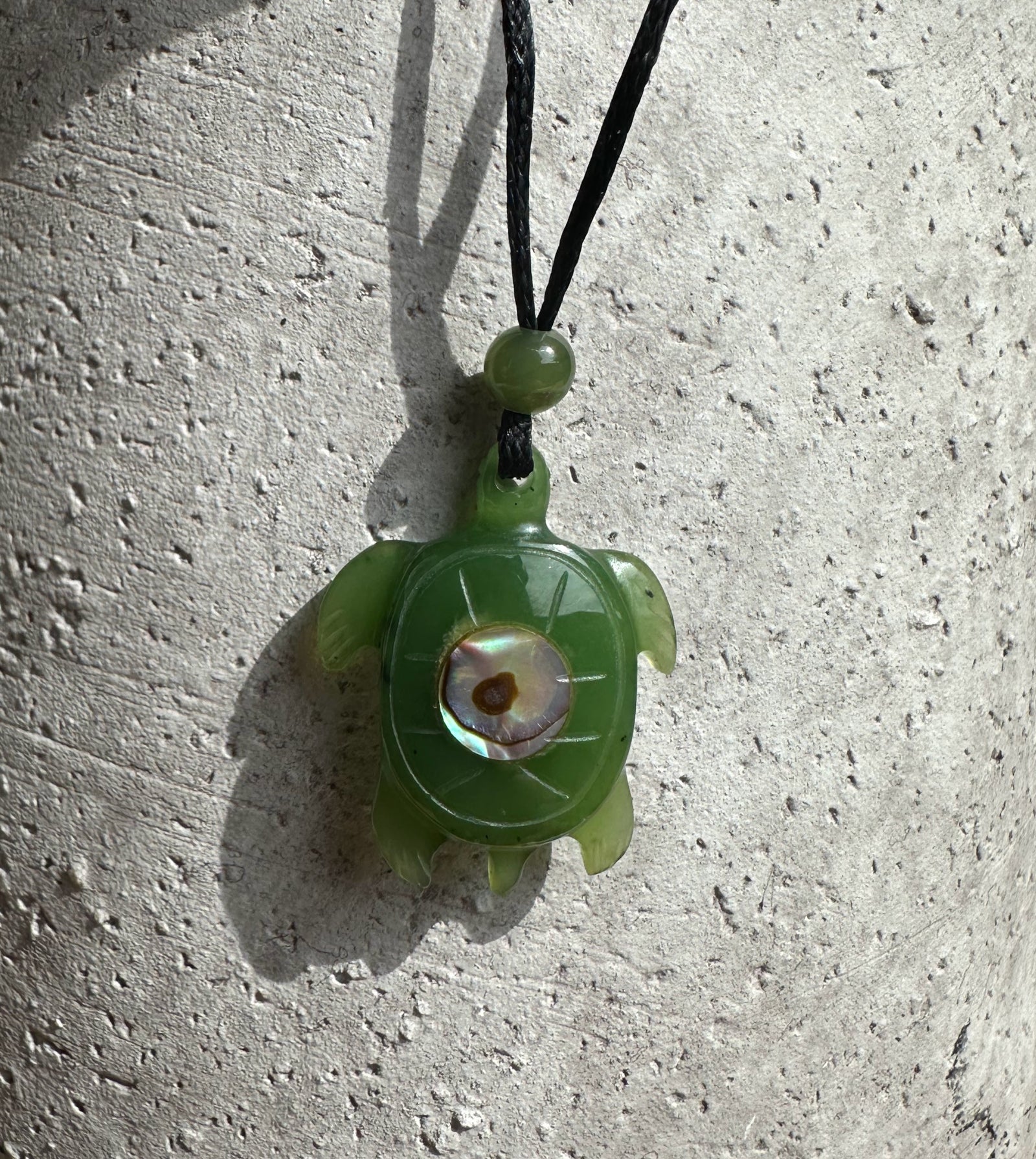 Green jade turtle pendant with a round abalone shell centerpiece