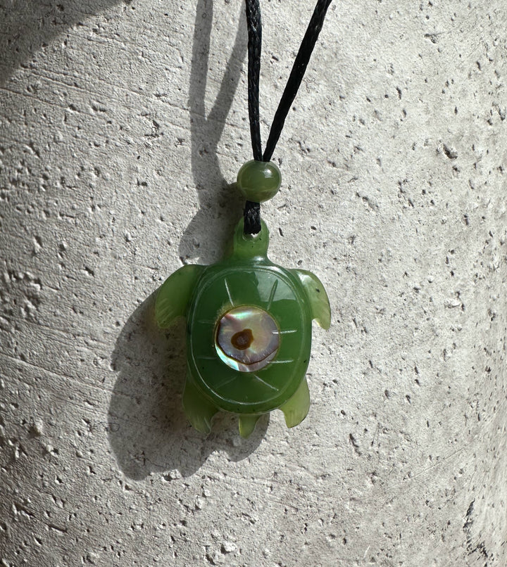 Green jade turtle pendant with a round abalone shell centerpiece