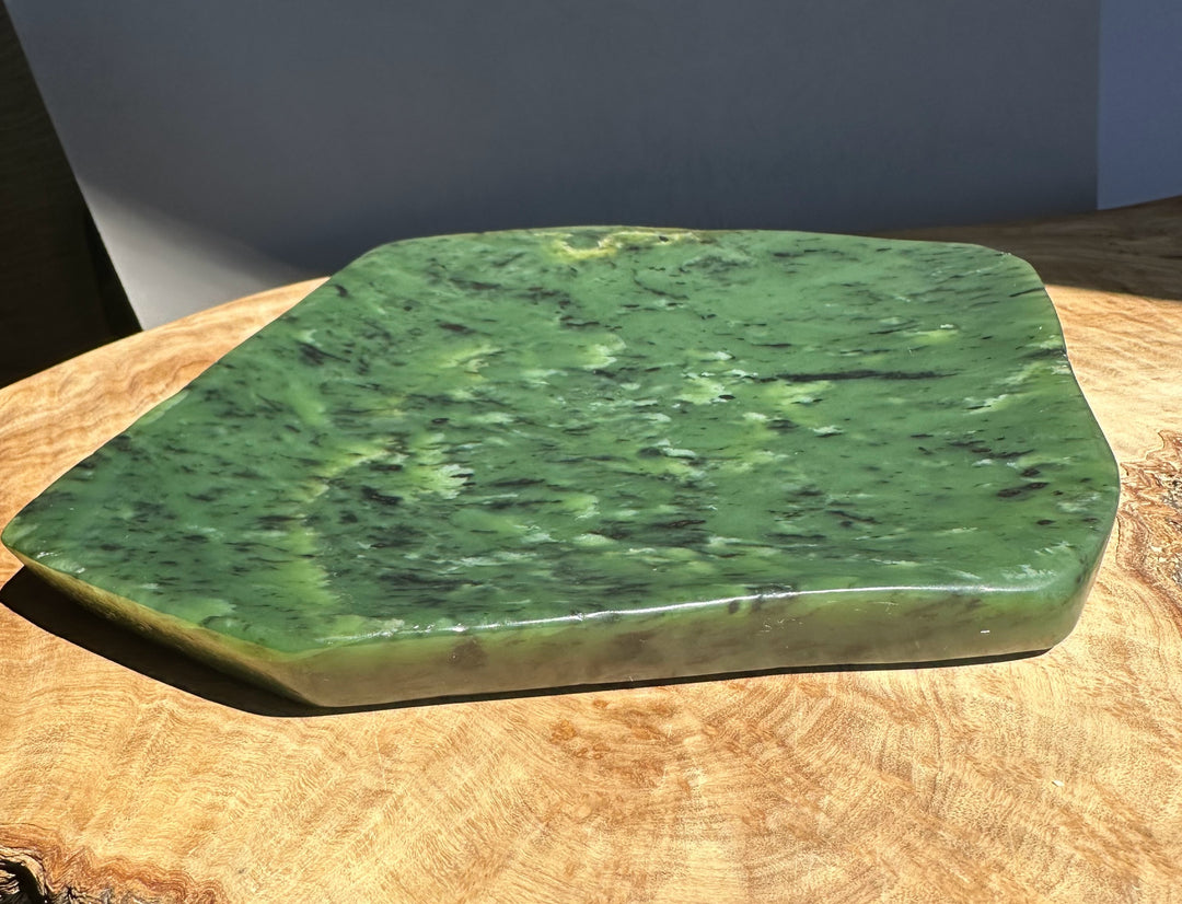 Green jade on a wooden surface with a neutral background