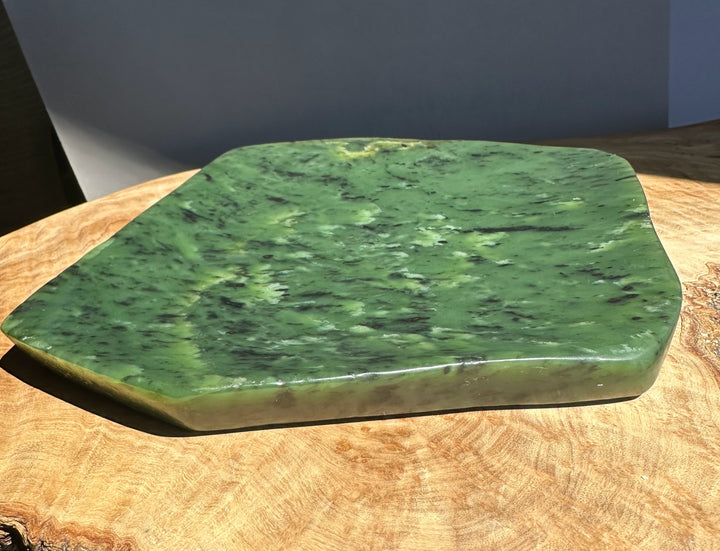 Green jade on a wooden surface with a neutral background