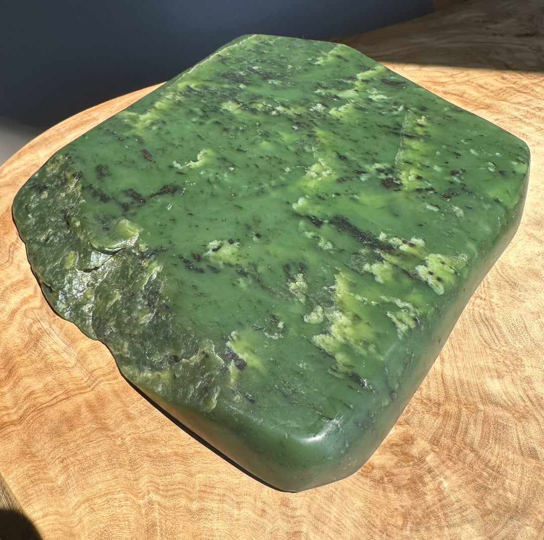 Green jade on a wooden surface