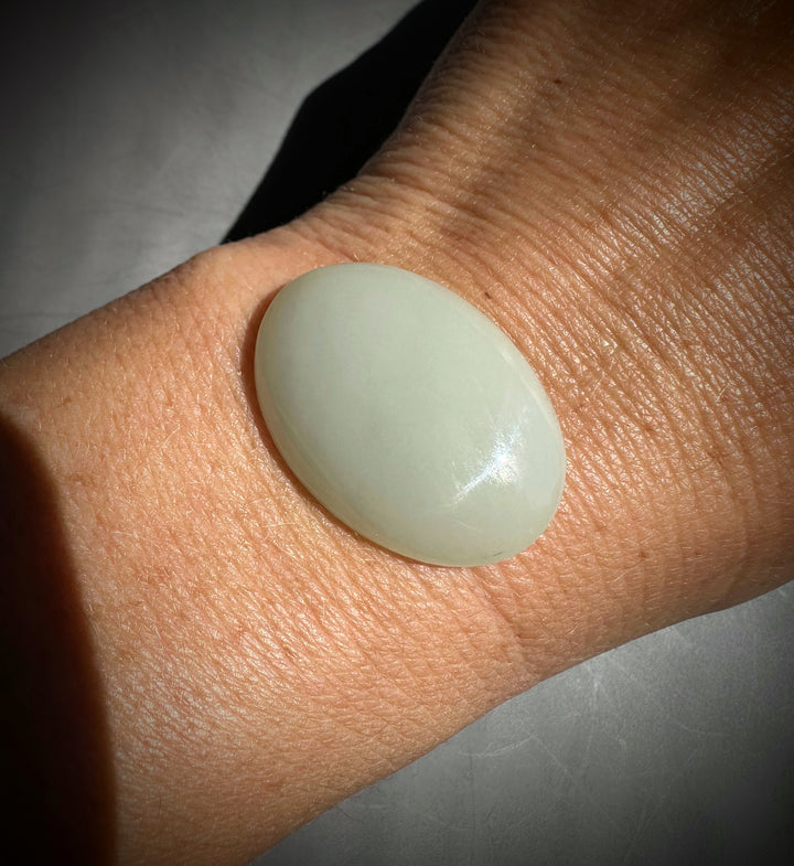 Light green//white stone on a person&