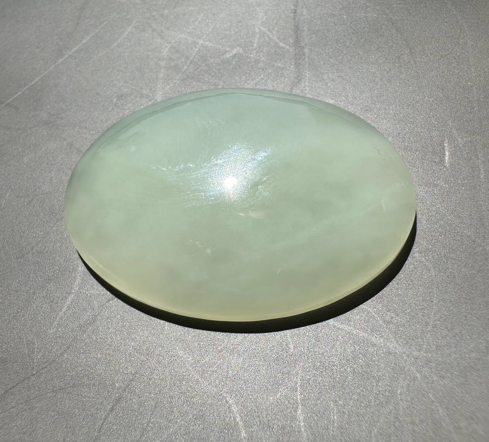 Off white jade on a gray surface