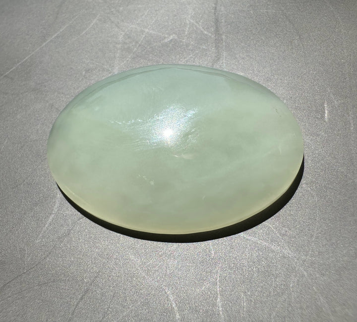 Off white jade on a gray surface