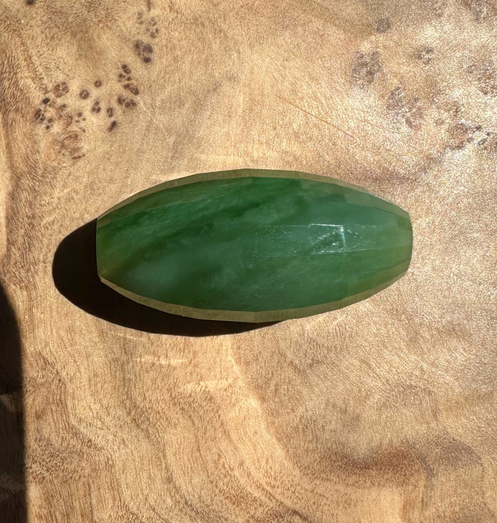 Green stone on a textured brown surface