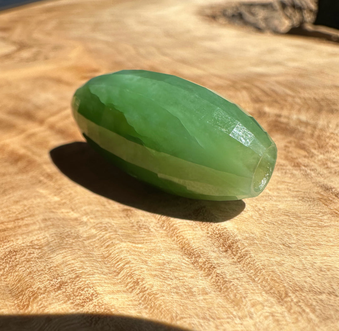 Green stone on a wooden surface