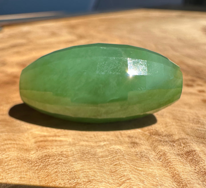 Green stone on a wooden surface