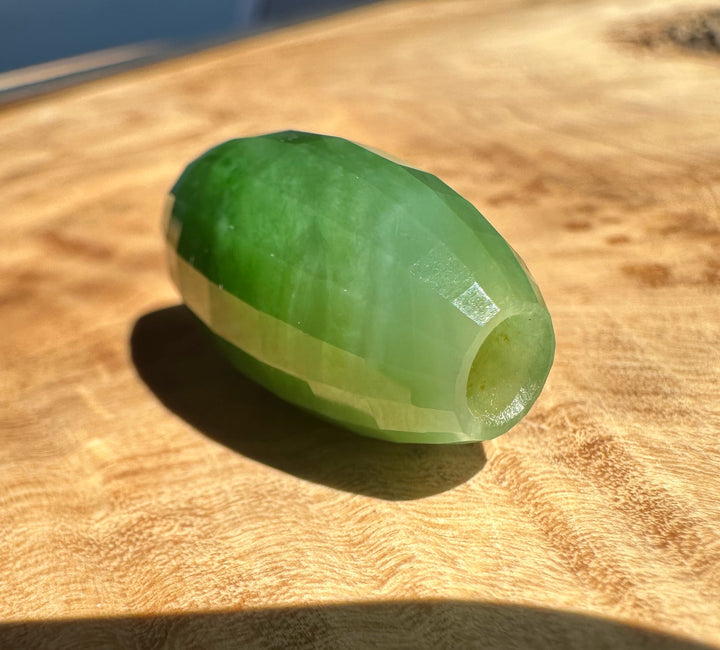 Green stone on a wooden surface