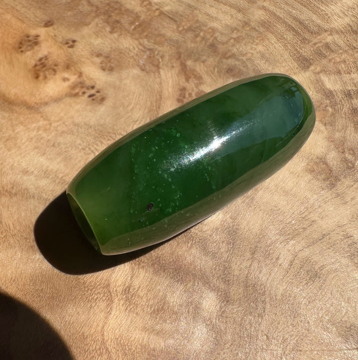 Green stone on a wooden surface