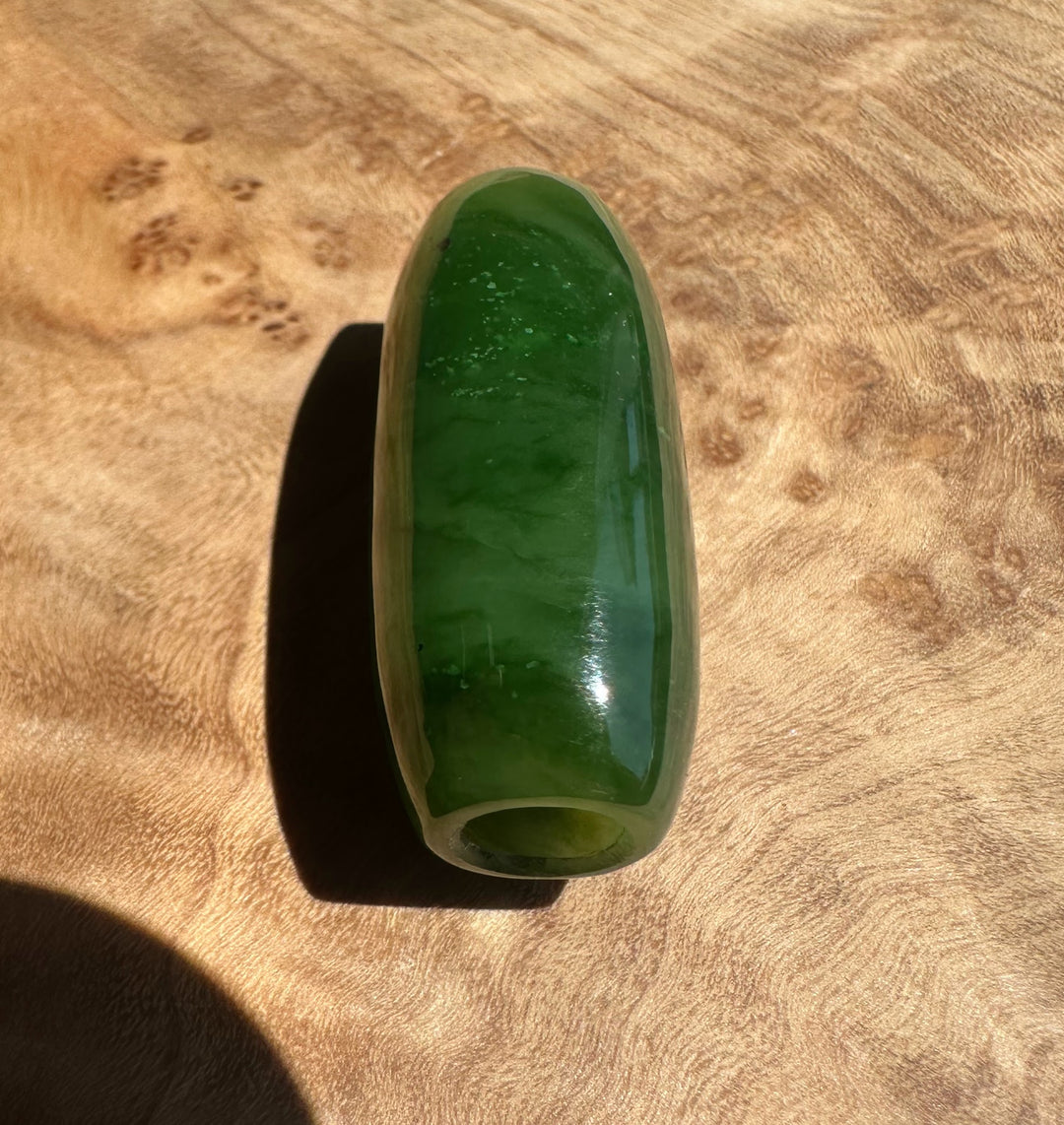Green stone on a wooden surface