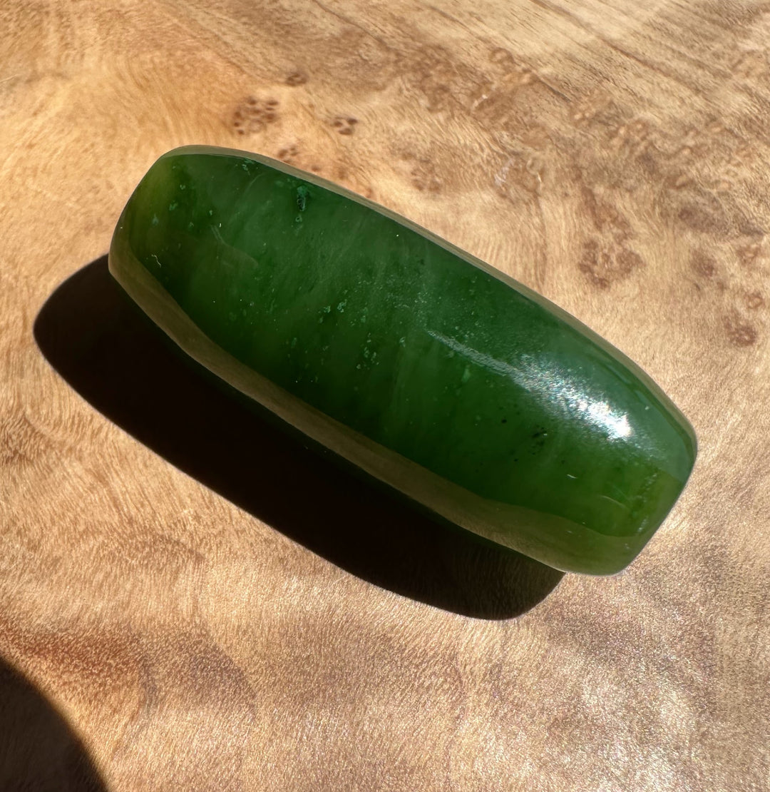 Green stone on a wooden surface