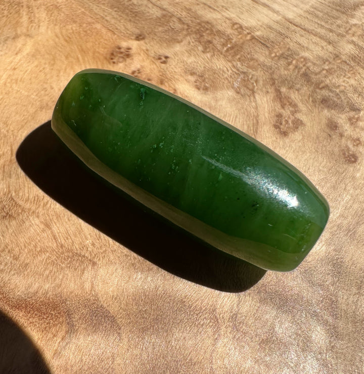 Green stone on a wooden surface